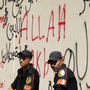 Security guards were deployed outside the graffiti-covered walls of the U.S. Embassy in Cairo, Egypt, which came under attack Tuesday. Security guards were deployed outside the graffiti-covered walls of the U.S. Embassy in Cairo, Egypt, which came under attack Tuesday.