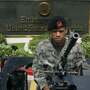 An armed police officer stood guard on a machine gun-mounted jeep outside the U.S. embassy in Manila, Philippines, amid warnings of a terrorist plot June 6, 2007.