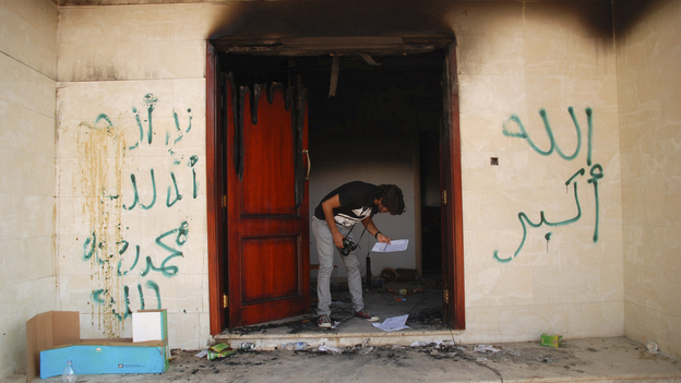 A man looks at documents at the U.S. Consulate in Benghazi, Libya, on Wednesday, after an attack that killed four Americans, including Ambassador Chris Stevens. The graffiti reads, "no God but God," " God is great," and "Muhammad is the Prophet." A man looks at documents at the U.S. Consulate in Benghazi, Libya, on Wednesday, after an attack that killed four Americans, including Ambassador Chris Stevens. The graffiti reads, "no God but God," " God is great," and "Muhammad is the Prophet."