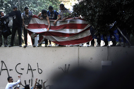 Protesters carry an American flag pulled down from the U.S. embassy in Cairo, Egypt on Tuesday. Protesters carry an American flag pulled down from the U.S. embassy in Cairo, Egypt on Tuesday.
