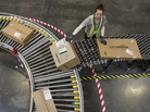 An Amazon worker sorts packages at a fulfillment center in Goodyear, Ariz. An Amazon worker sorts packages at a fulfillment center in Goodyear, Ariz.