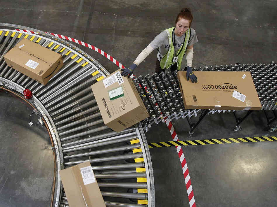 An Amazon worker sorts packages at a fulfillment center in Goodyear, Ariz. An Amazon worker sorts packages at a fulfillment center in Goodyear, Ariz.