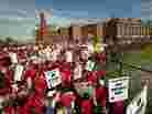 A crowd of Chicago public school teachers marches past John Marshall Metropolitan High School on Wednesday, Sept. 12.