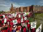A crowd of Chicago public school teachers marches past John Marshall Metropolitan High School on Wednesday, Sept. 12.
