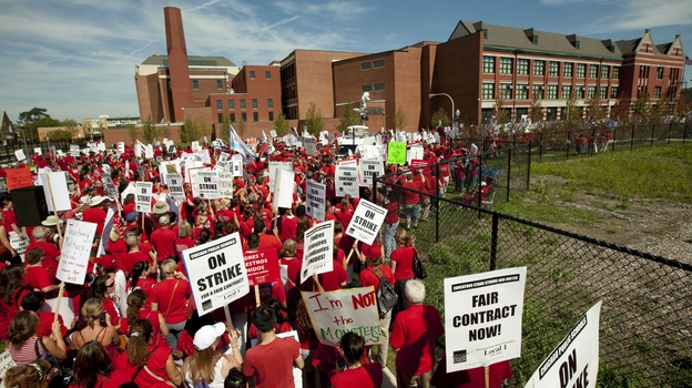 A crowd of Chicago public school teachers marches past John Marshall Metropolitan High School on Wednesday, Sept. 12.