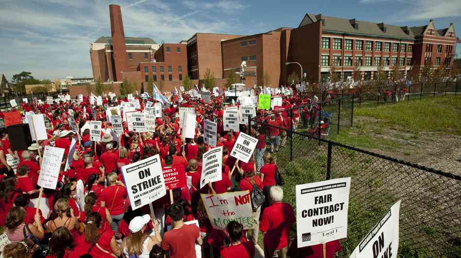 A crowd of Chicago public school teachers marches past John Marshall Metropolitan High School on Wednesday, Sept. 12.