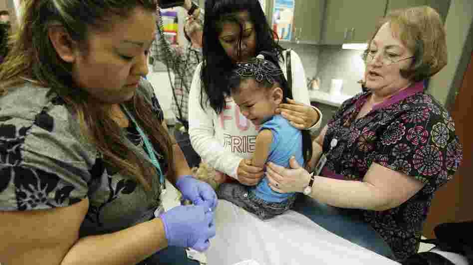 Nurse Fatima Guillen (left) gives 4-year-old Kimberly Magdeleno a whooping cough booster shot at a health clinic in Tacoma, Wash., in May.