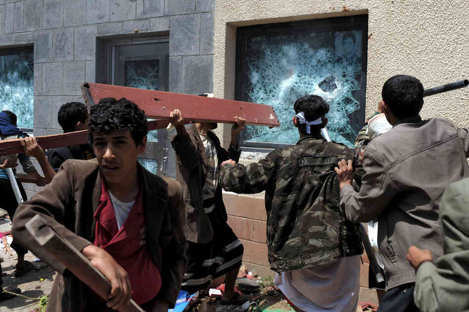 A mob in Yemen attacks the U.S. Embassy during a protest against a film they say insults the Prophet Muhammad, in the capital, Sanaa, on Thursday.