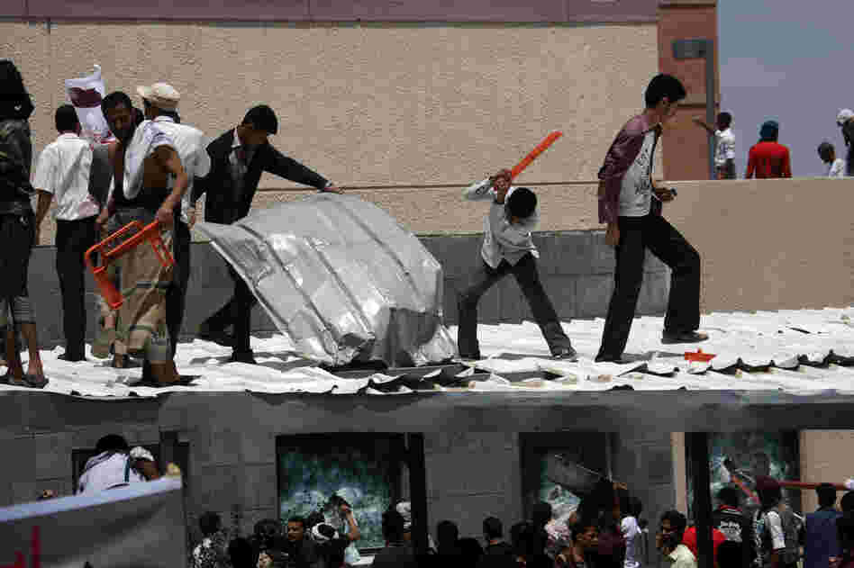 Yemeni protesters try to break through the U.S. Embassy in Sana'a during a protest over a film mocking Islam on Thursday. Yemeni forces managed to drive out angry protesters who stormed the embassy in the Yemeni capital with police firing warning shots to disperse thousands of people as they approached the main gate of the mission.