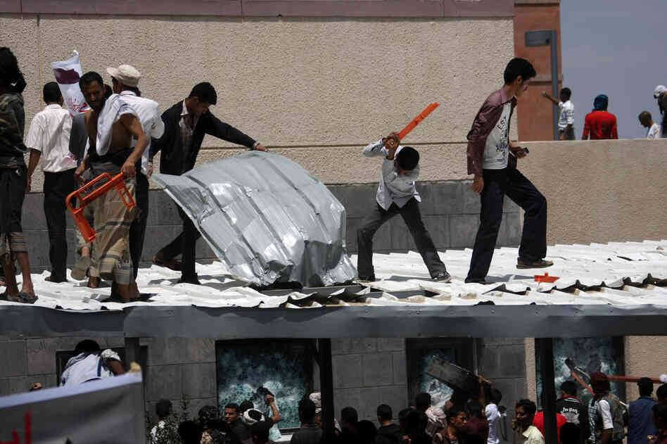 Yemeni protesters try to break through the U.S. Embassy in Sana'a during a protest over a film mocking Islam on Thursday. Yemeni forces managed to drive out angry protesters who stormed the embassy in the Yemeni capital with police firing warning shots to disperse thousands of people as they approached the main gate of the mission.