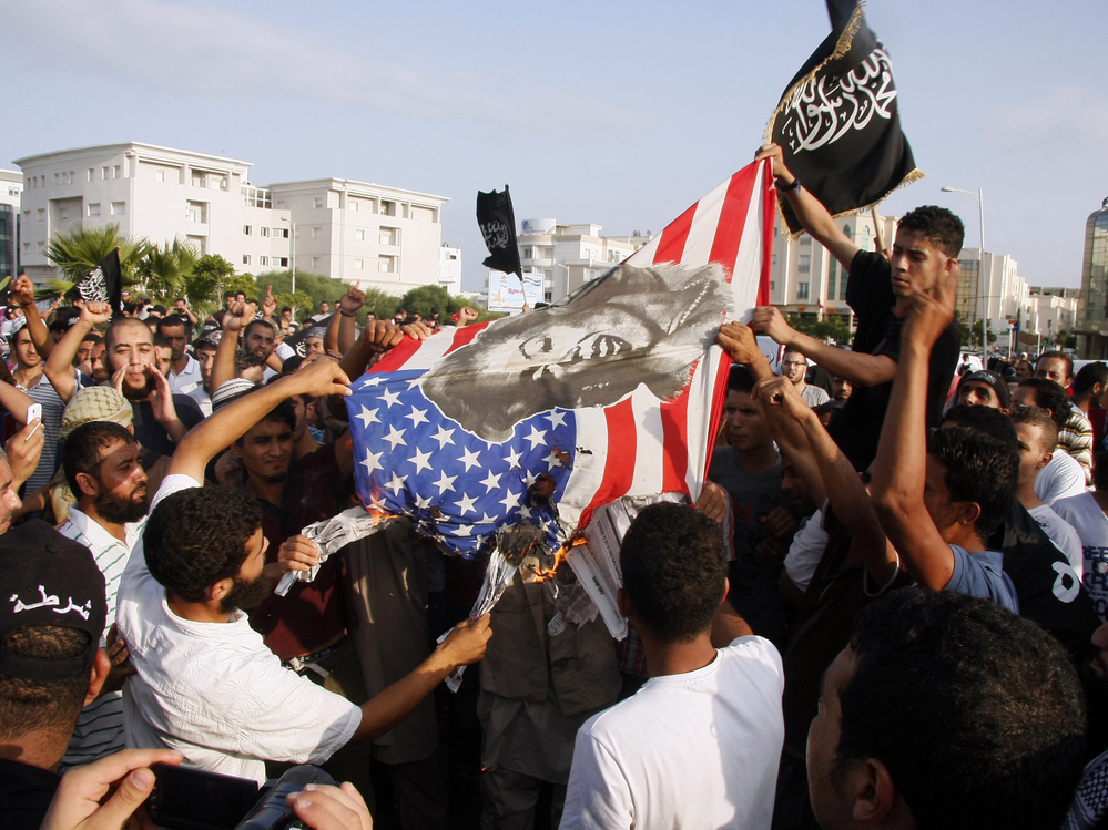 Protesters outside the U.S. embassy in Tunis burn an American flag bearing a portrait of Marilyn Monroe during a demonstration Wednesday against a film deemed offensive to Islam.
