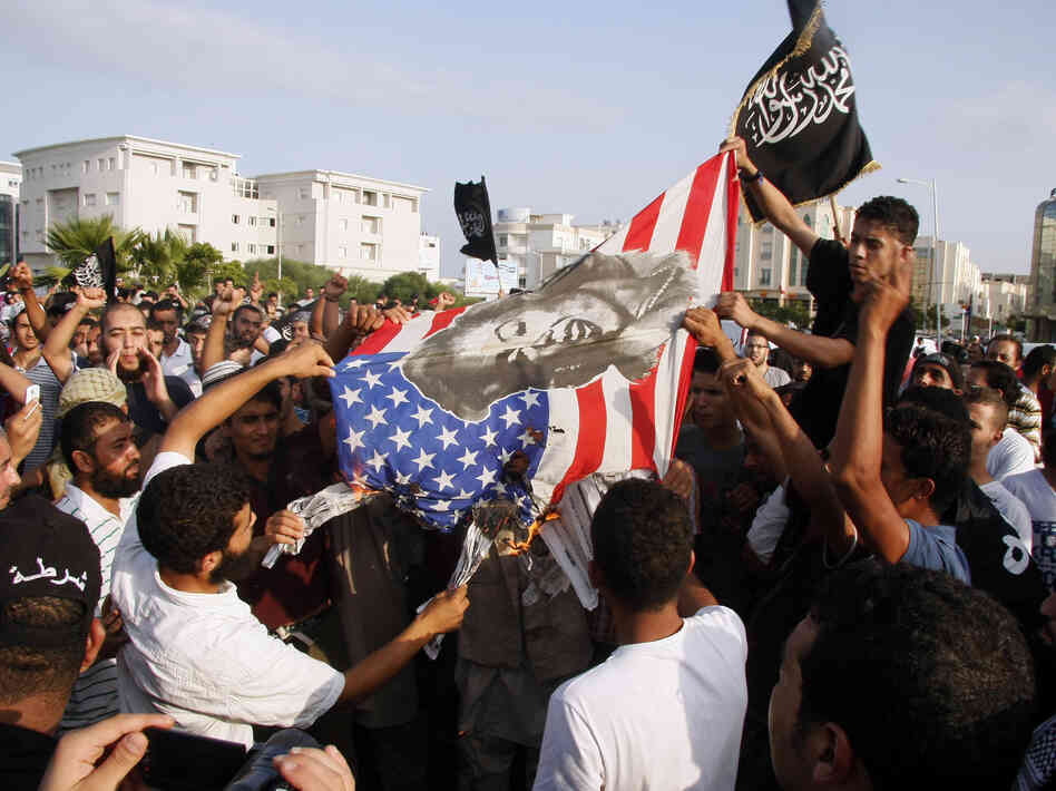 Protesters outside the U.S. embassy in Tunis burn an American flag bearing a portrait of Marilyn Monroe during a demonstration Wednesday against a film deemed offensive to Islam.