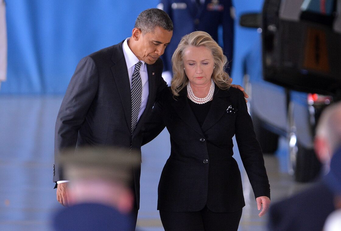 President Barack Obama and  Secretary of State Hillary Clinton return to their seats after speaking during the transfer of remains of the four Americans killed in an attack this week in Benghazi, Libya.