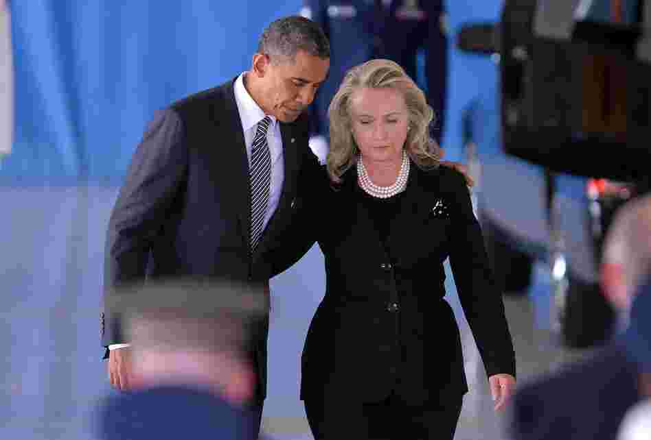 President Barack Obama and  Secretary of State Hillary Clinton return to their seats after speaking during the transfer of remains of the four Americans killed in an attack this week in Benghazi, Libya.