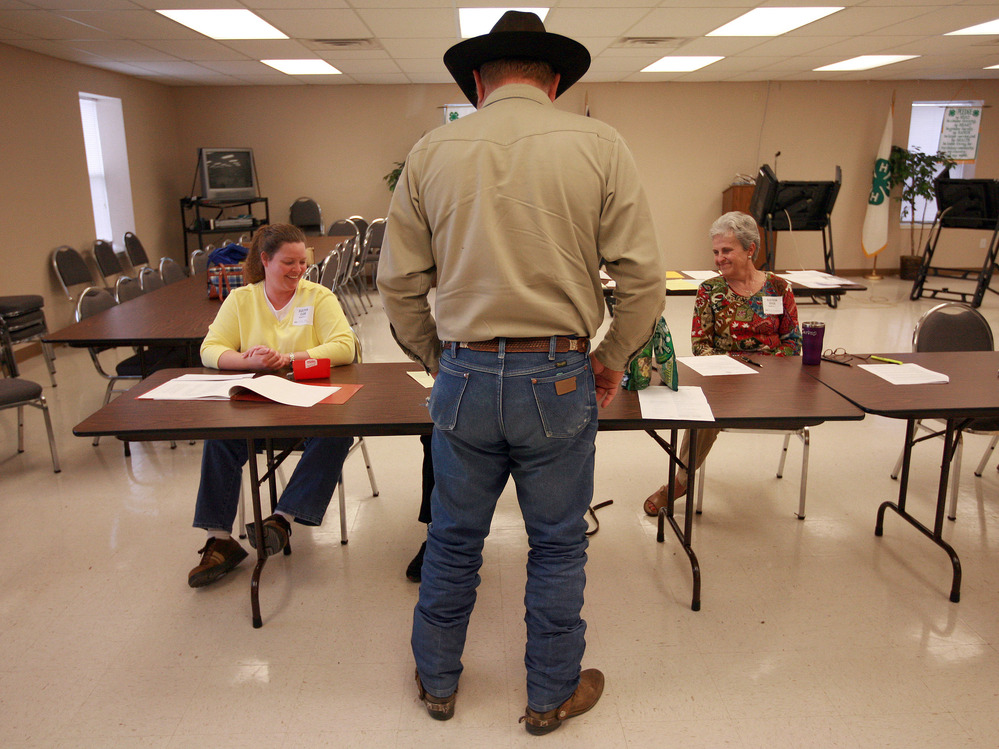 Volunteers check in a voter in Palo Pinto, Texas, in November 2008. The state is using a list from the Social Security Administration to purge dead voters from its election rolls.