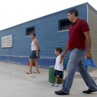 Parents take their children to School No. 103 on the first day of the new school year in Valencia, Spain, on Sept. 7. Spanish students, parents and teachers are feeling the pinch of the ongoing European debt crisis.