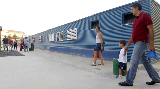Parents take their children to School No. 103 on the first day of the new school year in Valencia, Spain, on Sept. 7. Spanish students, parents and teachers are feeling the pinch of the ongoing European debt crisis.