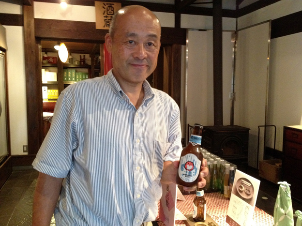 Kiuchi Brewery vice president Youichi Kiuchi holds a bottle of his company's Hitachino Nest beer. To make beer, the brewery is using equipment that once was used for sake.