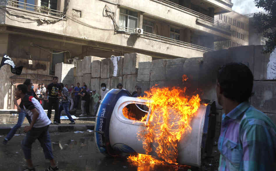 Protesters set a bank security booth on fire during a demonstration near the U.S. embassy in Cairo, Friday.