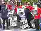 Chicago public school teachers pose for a photo on a picket line as their strike extends into a fifth day.