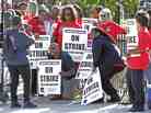 Chicago public school teachers pose for a photo on a picket line as their strike extends into a fifth day.