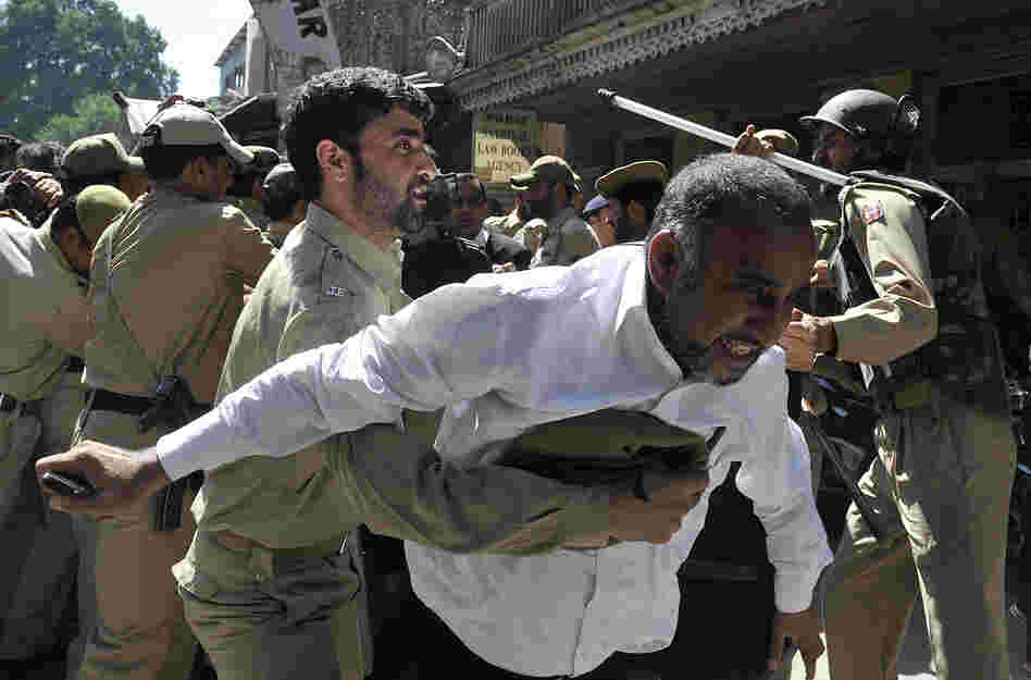 Police try to stop Kashmiri lawyers during a demonstration in Srinagar, India. The controversial low budget film portrays Muslims as immoral and gratuitous sparked fury in Libya, where four Americans including the ambassador were killed on Tuesday when a mob attacked the U.S. consulate in Benghazi.