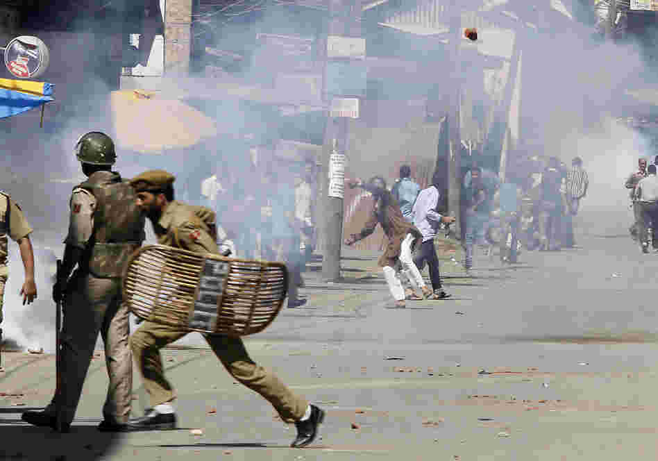 Kashmiri Muslim protesters throw stones at Indian policemen during a protest in Srinagar, India. The protest was held against an anti-Islam film called "Innocence of Muslims" that ridicules Islam's Prophet Muhammad.