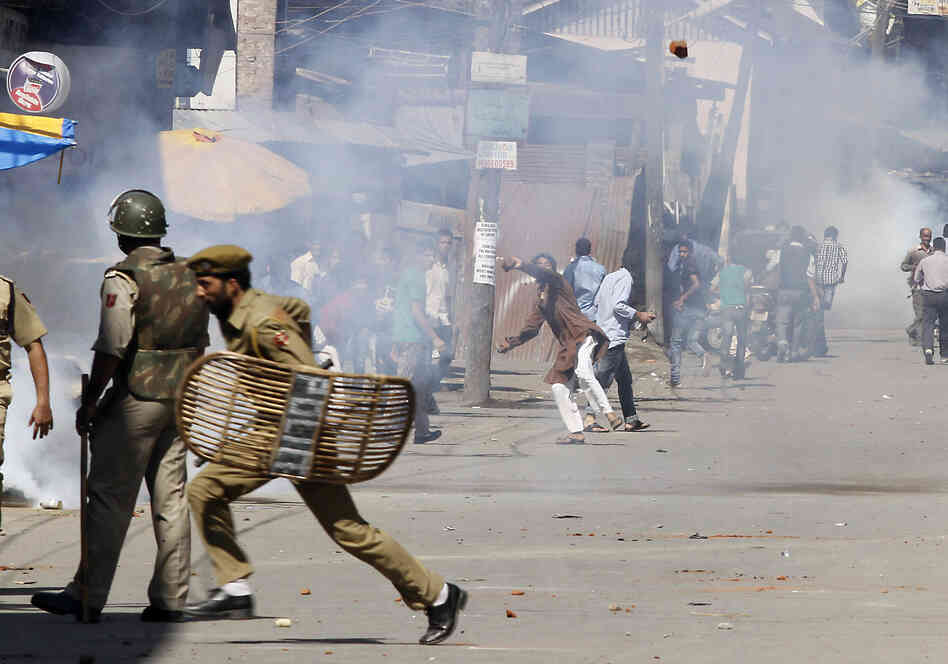 Kashmiri Muslim protesters throw stones at Indian policemen during a protest in Srinagar, India. The protest was held against an anti-Islam film called "Innocence of Muslims" that ridicules Islam's Prophet Muhammad.