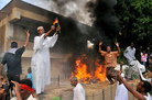 A Sudanese demonstrator burns a German flag as others shout slogans after torching the German embassy in Khartoum during a protest against a low-budget film mocking Islam on Friday. Around 5,000 protesters in the Sudanese capital angry over the amateur anti-Islam film stormed the embassies of Britain and Germany, which was torched and badly damaged. A Sudanese demonstrator burns a German flag as others shout slogans after torching the German embassy in Khartoum during a protest against a low-budget film mocking Islam on Friday. Around 5,000 protesters in the Sudanese capital angry over the amateur anti-Islam film stormed the embassies of Britain and Germany, which was torched and badly damaged.