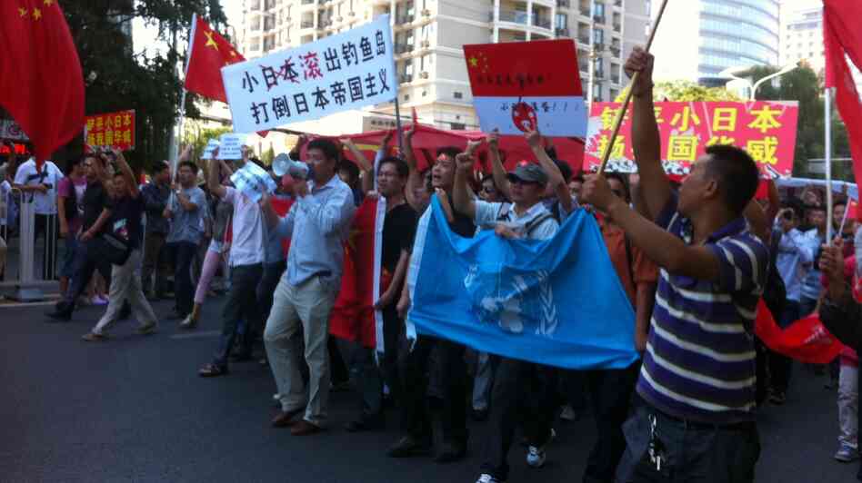 Protesters march outside the Japanese Embassy in Beijing on Saturday. Tension escalated, sometimes to violence, in cities across China after Japan bought the disputed islands from a private Japanese owner.