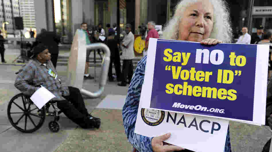 Gloria Gilman holds a sign Thursday in Philadelphia  during the NAACP voter ID rally to demonstrate her opposition to Pennsylvania's new voter identification law.