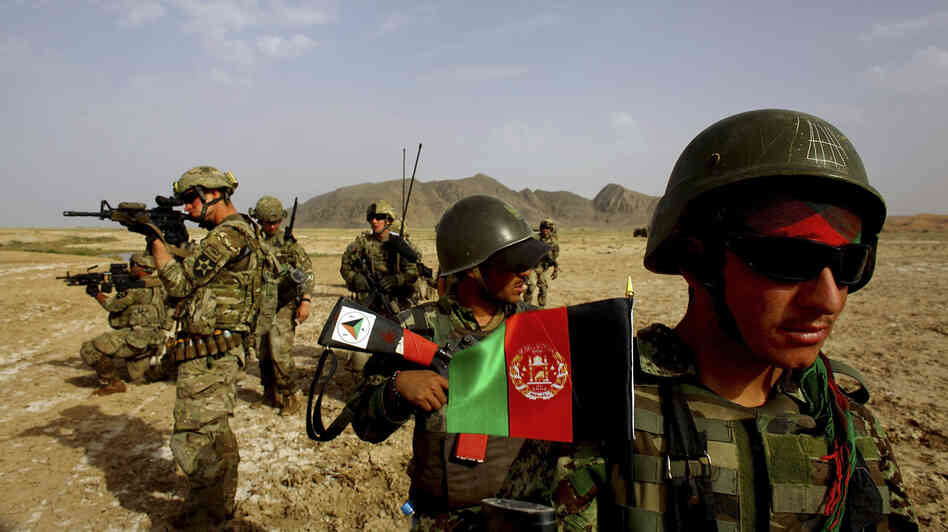 Afghan soldiers (right) patrol with U.S. troops in the Panjwai district of southern Afghanistan in May. The two armies have been working together for years, but Afghan attacks against U.S. and NATO forces have been rising recently.