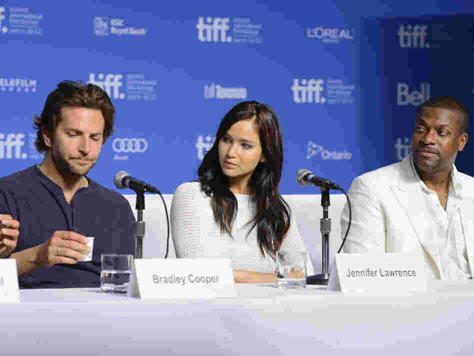 Actors Bradley Cooper (left), Jennifer Lawrence and Chris Tucker speak onstage at Silver Linings Playbook press conference Sept. 9 during the 2012 Toronto International Film Festival.