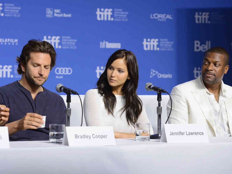 Actors Bradley Cooper (left), Jennifer Lawrence and Chris Tucker speak onstage at Silver Linings Playbook press conference Sept. 9 during the 2012 Toronto International Film Festival.