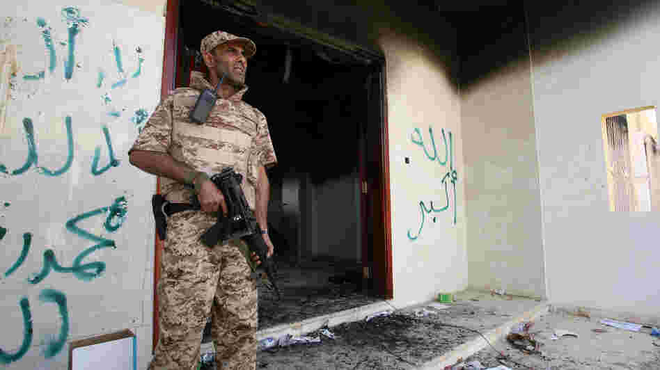A Libyan military guard stands in front of one of the U.S. Consulate's burnt-out buildings in Benghazi Sept. 14 during the visit of President Mohammed el-Megarif.