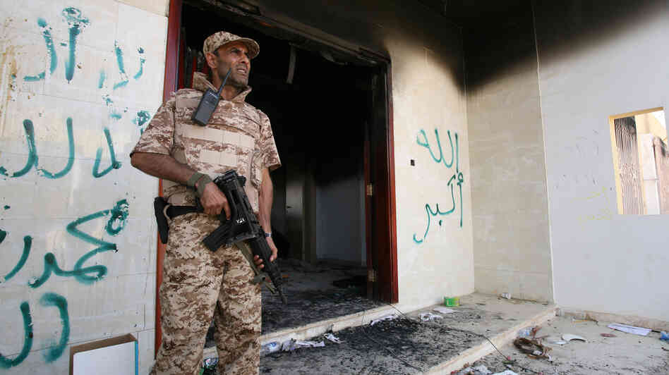 A Libyan military guard stands in front of one of the U.S. Consulate's burnt-out buildings in Benghazi Sept. 14 during the visit of President Mohammed el-Megarif.