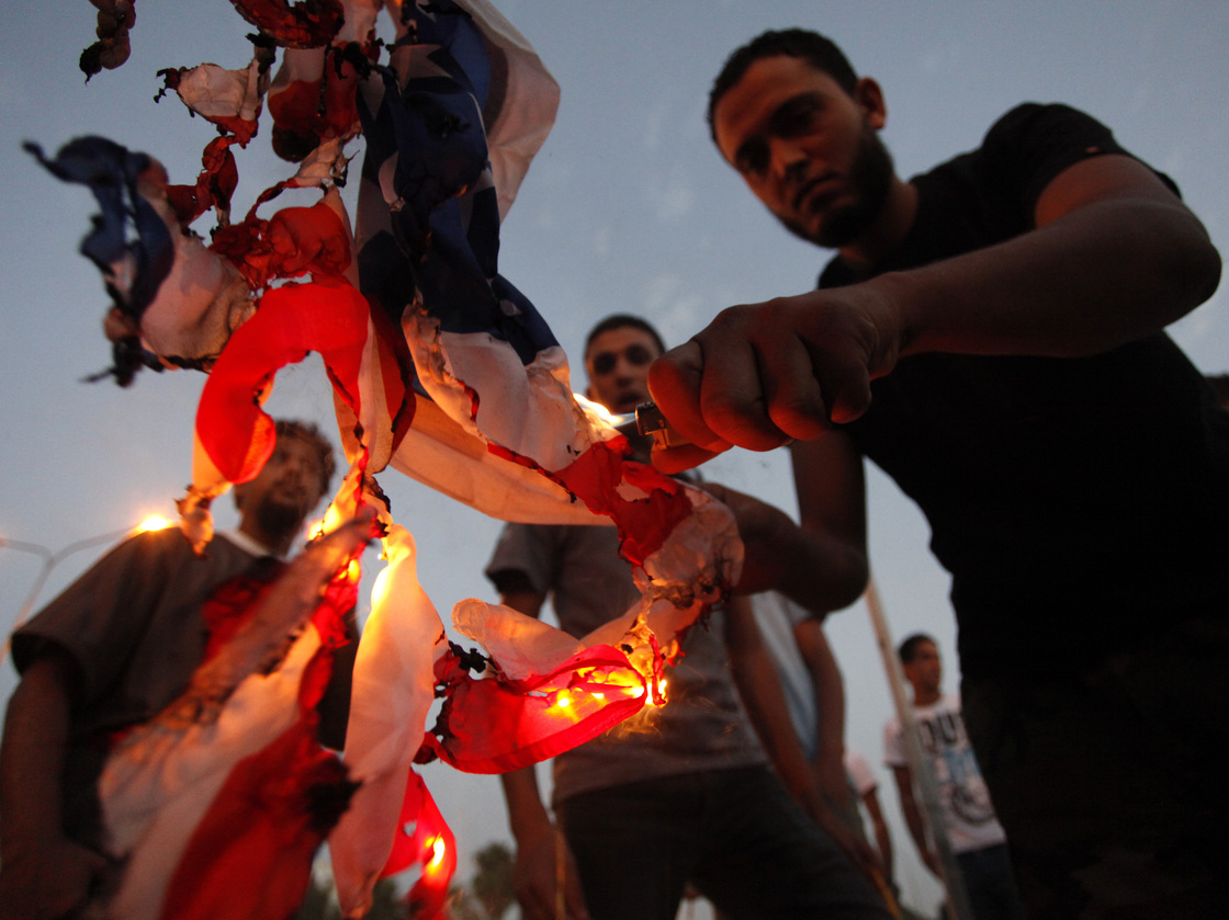 Libyan followers of the Ansar al-Sharia militant group burn the U.S. flag during a protest in  Benghazi, Libya, on Sept. 14.
