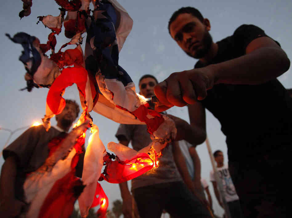 Libyan followers of the Ansar al-Sharia militant group burn the U.S. flag during a protest in  Benghazi, Libya, on Sept. 14.