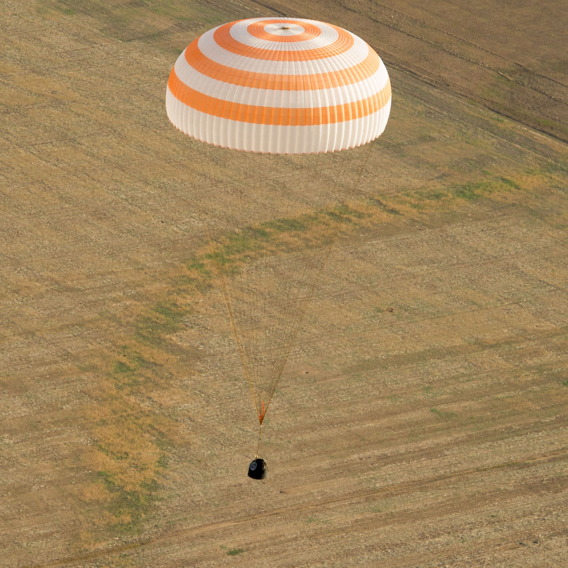 The Soyuz capsule floats as it brings Commander Gennady Padalka of Russia, NASA Flight Engineer Joe Acaba and Russian Flight Engineer Sergei Revin to a landing area near the town of Arkalyk, Kazakhstan. When it detached from the space station, the capsule was over Kenya.