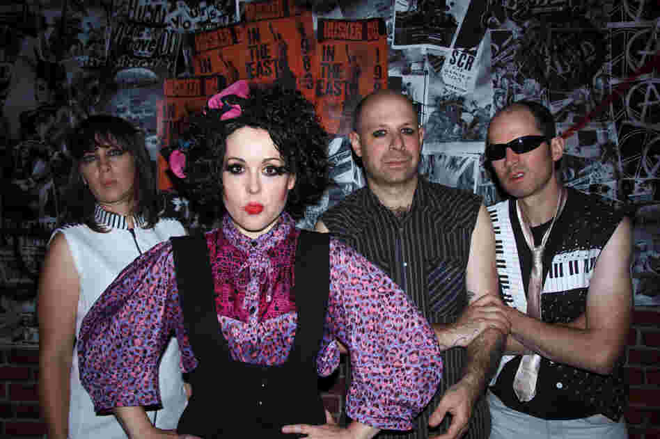 The Corin Tucker Band, from left: Sarah Lund, Corin Tucker, Seth Lorinczi and Mike Clark — dressed up as X-Ray Spex in the video for "Neskowin." The Corin Tucker Band, from left: Sarah Lund, Corin Tucker, Seth Lorinczi and Mike Clark — dressed up as X-Ray Spex in the video for "Neskowin."