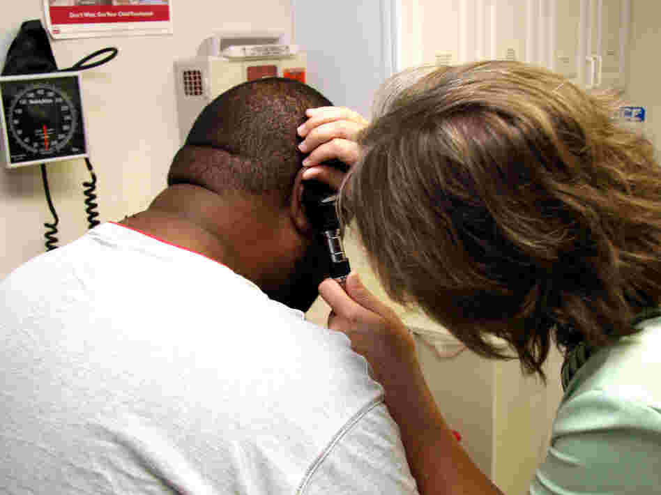 A Unity Health Care patient gets his ears checked.