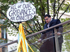 A man looks down at a sign during the Occupy Wall Street protest on the one year anniversary of the movement in New York. A man looks down at a sign during the Occupy Wall Street protest on the one year anniversary of the movement in New York.