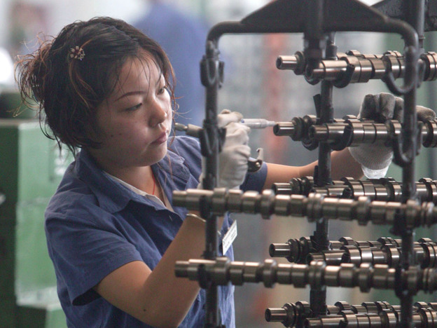A worker inspects auto parts at a factory in Chengdu, China. (2005 file photo.)