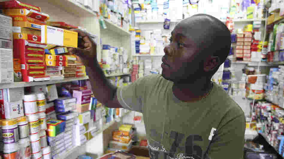 Ayo Bello grabs a box of malaria medication at a pharmacy in Lagos, Nigeria. A pilot project by the Global Fund has helped private pharmacies and clinics sell top quality malaria drugs at wholesale prices in Nigeria and seven other African countries.