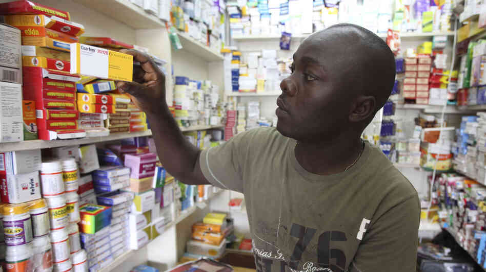 Ayo Bello grabs a box of malaria medication at a pharmacy in Lagos, Nigeria. A pilot project by the Global Fund has helped private pharmacies and clinics sell top quality malaria drugs at wholesale prices in Nigeria and seven other African countries.