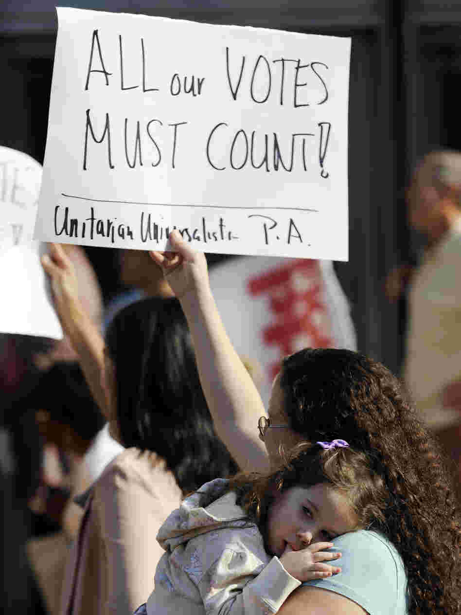 Emily Goldberg holds up a sign during the NAACP voter ID rally opposing Pennsylvania's voter ID law last Thursday in Philadelphia. With her is her 2-year-old daughter, Willa.