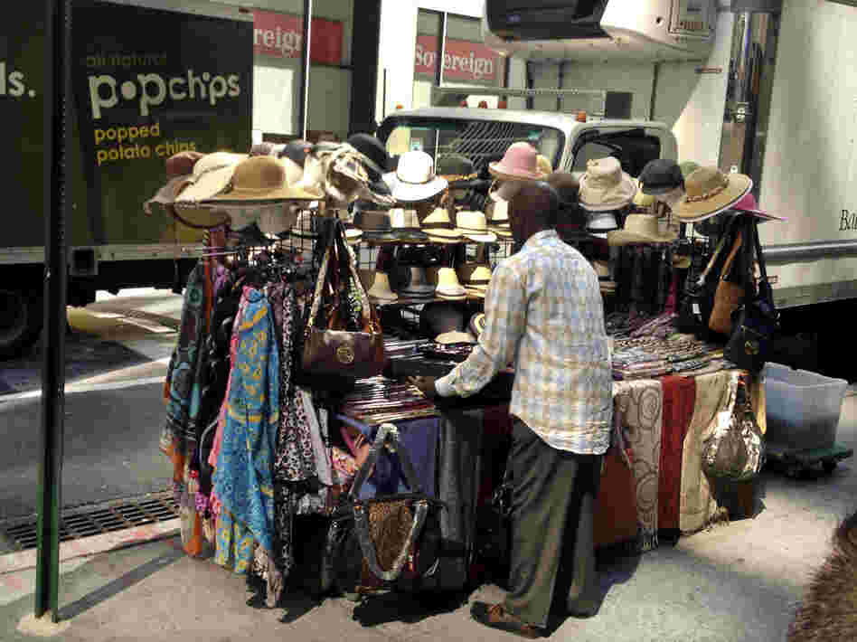 Cheikh Fall sets up his stall. He lives by the motto, "Work like you're never gonna die, and worship like you will die tomorrow."
