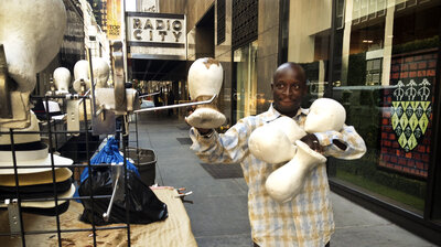 Senegalese vendor Cheikh Fall prepares his stall in front of Brooks Brothers on 51st Street, just off the Avenue of the Americas in New York City. Fall runs an association of Senegalese vendors that deals with the city over licensing and regulations.