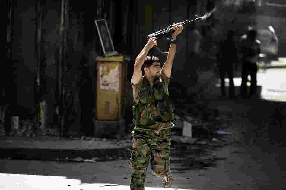 A Syrian rebel fires toward a position held by regime forces during clashes in the northern city of Aleppo on Sept. 14. A Syrian rebel fires toward a position held by regime forces during clashes in the northern city of Aleppo on Sept. 14.