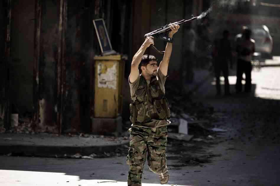 A Syrian rebel fires toward a position held by regime forces during clashes in the northern city of Aleppo on Sept. 14. A Syrian rebel fires toward a position held by regime forces during clashes in the northern city of Aleppo on Sept. 14.